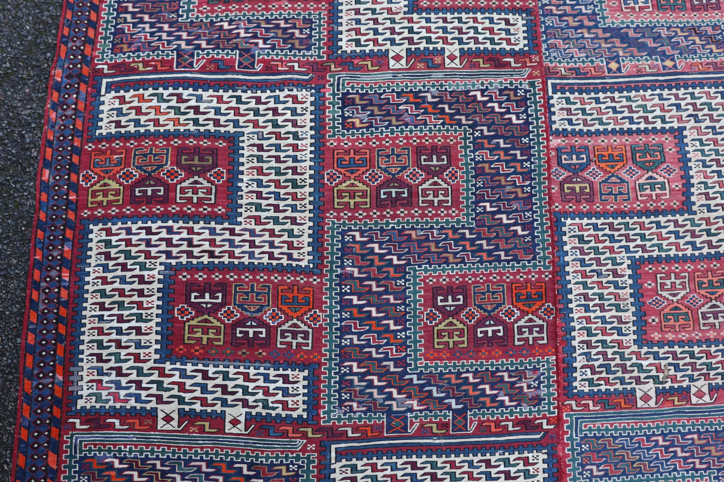 A Sumak weave 2-sectional carpet, combined dimension - 320 x 230cm.